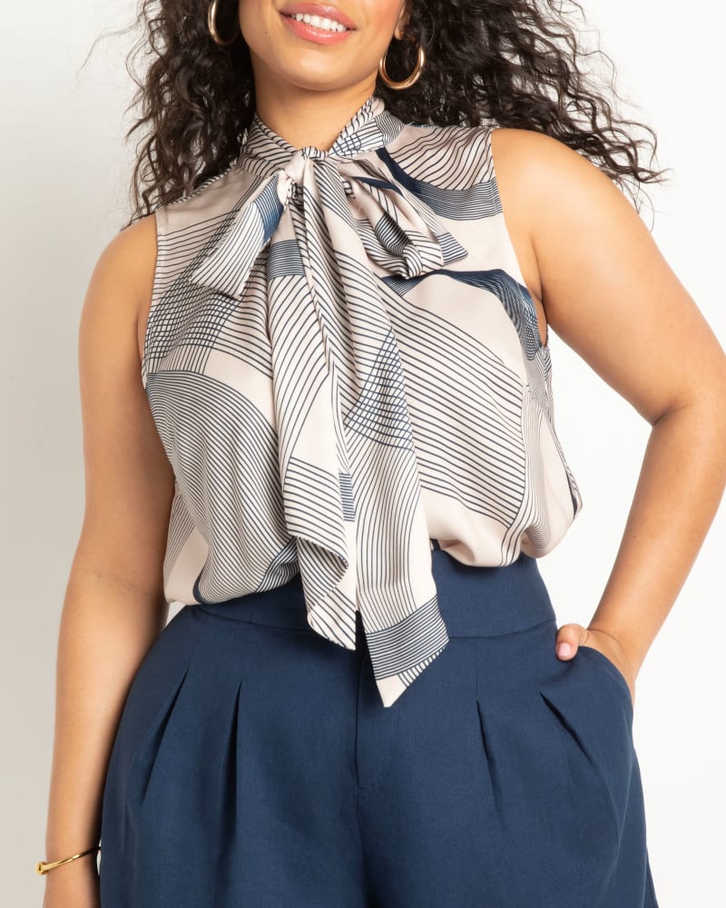 Front of a model wearing a size 14 Satin Bow Blouse in Linear Curves by ELOQUII. | dia_product_style_image_id:294998